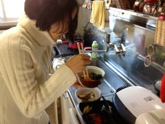 Lisa busy cooking our New Year's osechi. She cooked for two days straight. I helped.